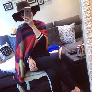 Detail shot of heavy geometric cashmere-feel shawl with navy, red, and brown color blocking