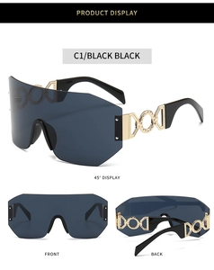 Detail of shield sunglasses showing golden metal temples with hollow geometric rings