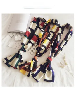 Three-piece long silk scarf set with geometric color blocks shown in flat lay arrangement