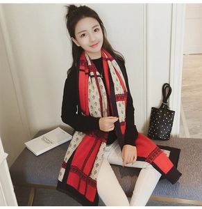 Detail of red and black retro ethnic floral scarf with lace patterns and soft texture
