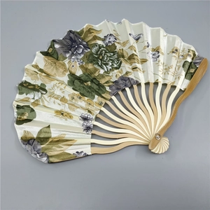 Detail view of beige fabric fan with floral patterns and wavy bamboo bone design