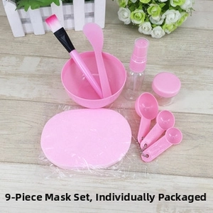 Detailed view of pink 9-piece DIY facial mask kit with mixing tools and measuring spoons