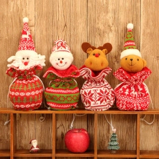 Detail of four knitted Christmas drawstring gift bags with 3D Santa and Reindeer dolls