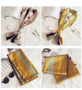 Detail view of long silk scarves with classic polka dots and geometric patterns