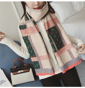 Close-up of vintage geometric patterns and tassels on a thick faux cashmere shawl