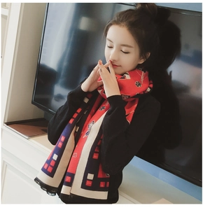 Close-up of thick pashmina scarf featuring red geometric patterns and floral print detail