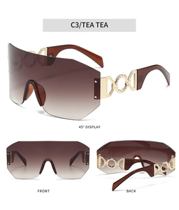 Detail of oversized shield sunglasses with gold CD hinge and brown gradient lenses