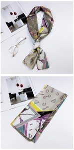 Detail of horsebit and chain print on a double-sided silk scarf with vibrant geometric patterns