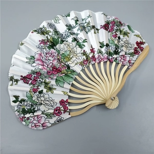 Detailed close-up of a Japanese folding fan with floral fabric and bamboo ribs