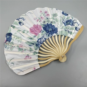 Close-up of Japanese style handheld fan with blue and pink floral patterns on fabric