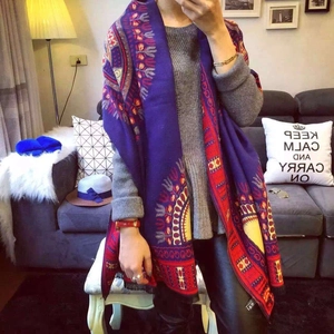 Detailed view of bohemian shawl showing intricate ethnic patterns and fine tassel fringe edges