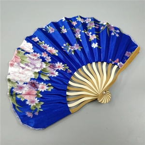 Top view of a dark blue silk folding fan featuring elegant pink floral patterns and bamboo ribs