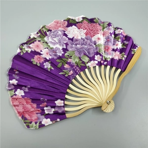 Detail of silk folding fan featuring purple fabric with elegant peony flower patterns