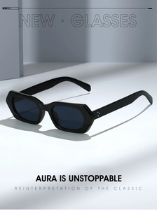 Detail of chunky hexagonal black sunglasses with silver rivet accents and dark lenses