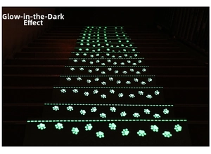 Detailed view of luminous cat paw patterns glowing in the dark on stair treads