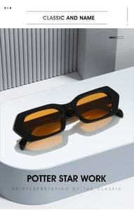 Detailed macro of orange lenses and thick black frames with stylish rivet accents