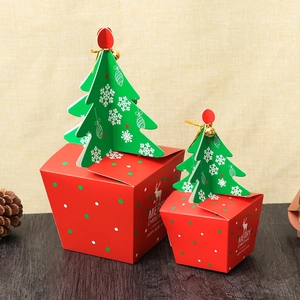 Christmas gift boxes with red green polka dots and tree design on dark wood table