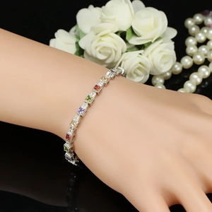 Elegant silver bracelet with multi-color square crystals on wrist with pearls and roses