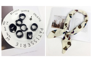 Detail of black leather scarf buckle with sparkling crystal button on elegant scarf