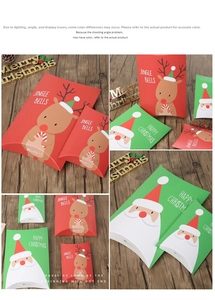 Detail of red reindeer and green Santa Claus pillow-shaped Christmas gift boxes on wood