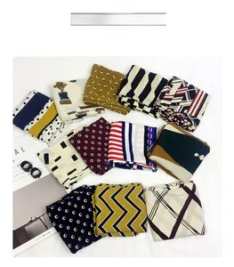 Detailed arrangement of thick cotton-linen square scarves featuring assorted geometric patterns