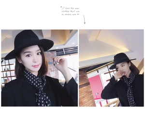 Detail of a chic black wide-brim wool hat and polka dot silk scarf on a model