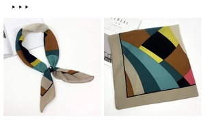 Detail of color-block geometric silk scarf with beige and green patterns and props
