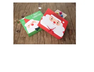 Detailed view of red and green Christmas Eve apple gift boxes with festive ribbons