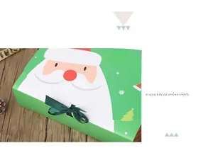 Detail of green Christmas gift box with Santa illustration, bow ribbon, and pine cone decor