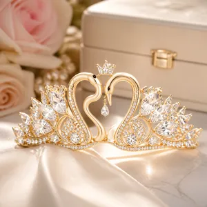 Detail view of silver tiara featuring twin swan designs encrusted with white crystals