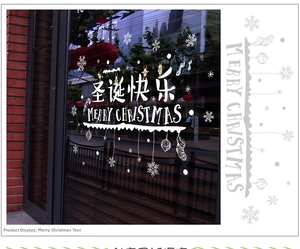 Detail of white Christmas window stickers featuring Merry Christmas text and reindeer