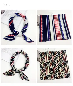 Detail of red-white-blue striped and navy geometric silk scarves with a leather buckle
