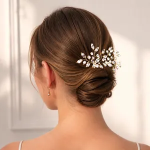 Detailed view of handmade pearl hair pin with crystal leaves on a bridal bun hairstyle