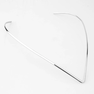 Macro shot of minimalist silver V-shaped necklace collar with smooth polished metal finish