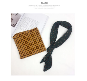 Detail of yellow and dark green cotton linen square scarves with paisley patterns and silk sheen