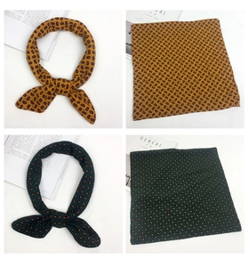 Detail of yellow and dark green paisley printed square scarves with vintage texture