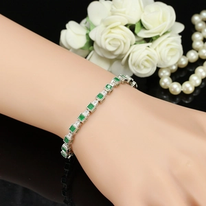 Elegant emerald silver bracelet with cubic link design on woman's wrist with roses