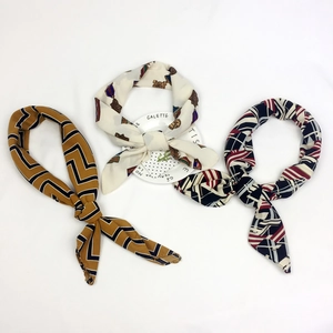 Three patterned cotton linen square scarves with geometric and medallion prints in classic tones
