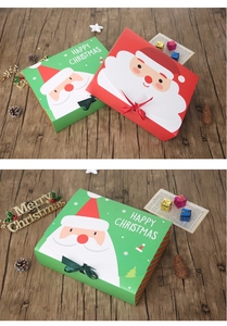 Detail of red and green Christmas gift boxes with Santa Claus motifs on warm wood background