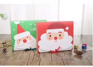 Detailed view of red and green Santa Claus gift boxes with ribbon on wooden background