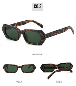 Detail view of tortoiseshell polygon sunglasses with metal rivets and green lenses