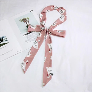 Close-up of pink narrow silk scarf with white swan print and smooth polyester texture