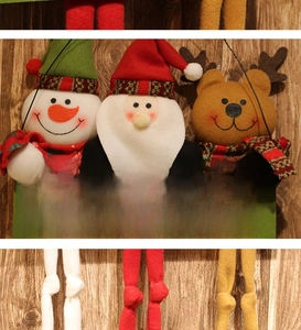 Close-up of Merry Christmas wooden sign with plush Santa, Snowman, and Reindeer dolls