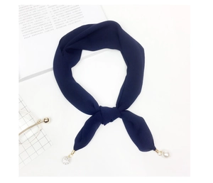 Navy blue chiffon scarf detail featuring a white faux pearl and rhinestone ball pendant