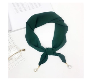 Detail of dark green chiffon scarf featuring elegant pearl and crystal ball pendant charms
