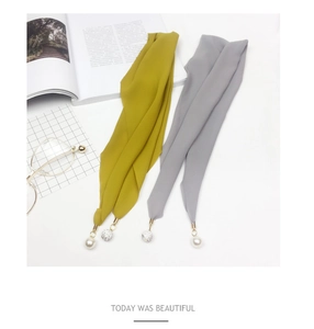 Close-up of lightweight chiffon scarves featuring pearl and crystal ball metal charms