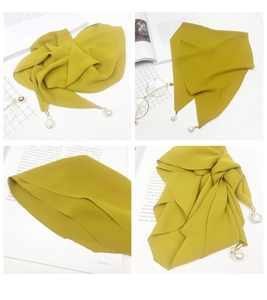 Detail of ginger yellow chiffon scarf with white pearls and sparkling rhinestone ball pendant
