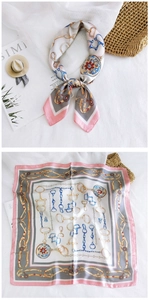 Detail view of pink and grey gradient silk scarf with equestrian horse bit pattern