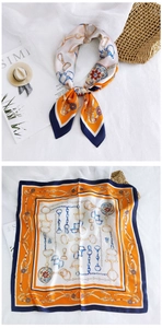 Detailed macro of a high-quality satin silk square scarf with classic equestrian chain pattern