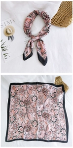 Detail of square silk scarf showing vintage paisley patterns and silky texture gradient
